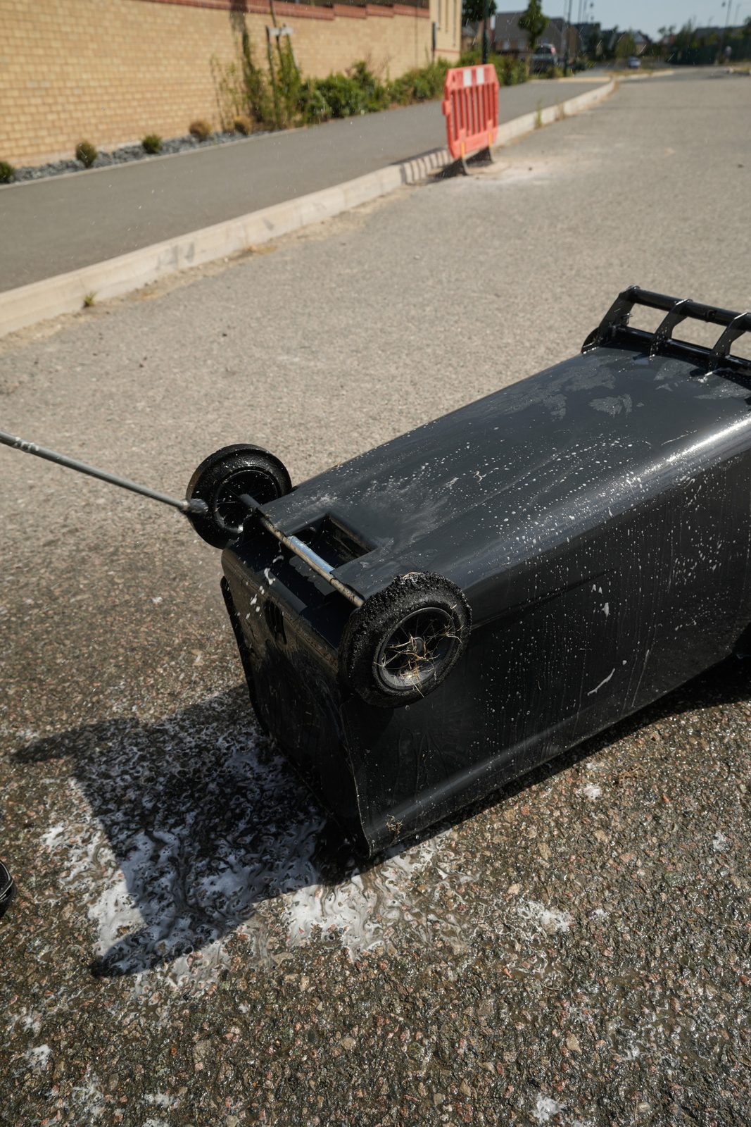 Pressure washing the side of a wheelie bin